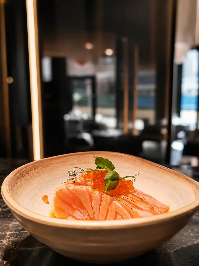Salmone aburi con uova ikura in ciotola di ceramica